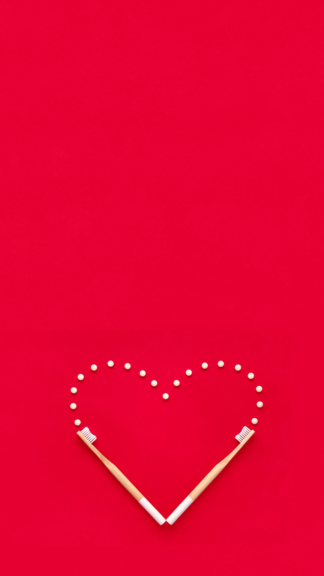 Creative heart shape on the red background with 2 Ecopify Bamboo Toothbrush and toothpaste